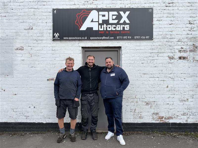 BookMyGarage employee posing outside Apex Autocare Ltd garage in Stockport with garage employees